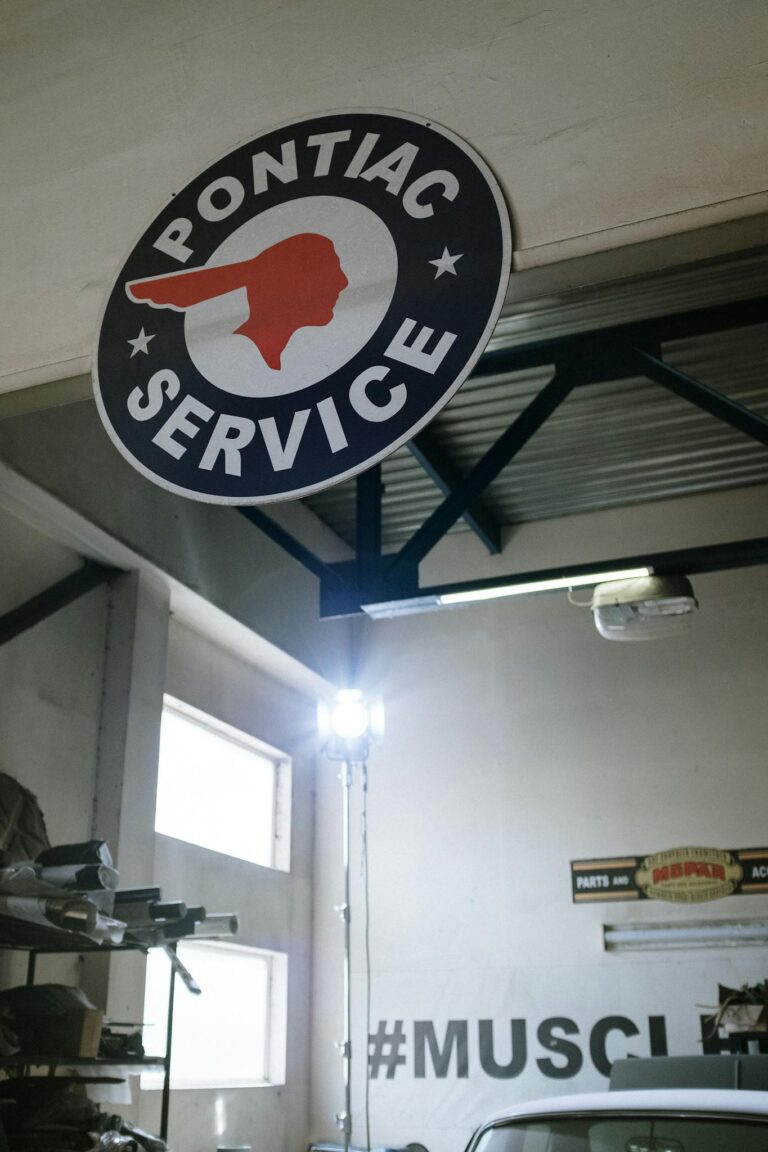 Classic Pontiac service sign hanging in a retro car garage.